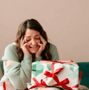 EMOTIONAL woman with poorly wrapped gift