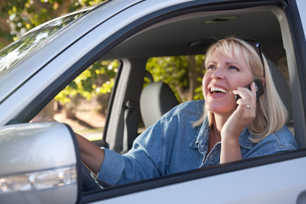 woman talking on her cell phone in car